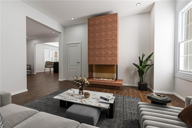 living room featuring recessed lighting, wood finished floors, and baseboards