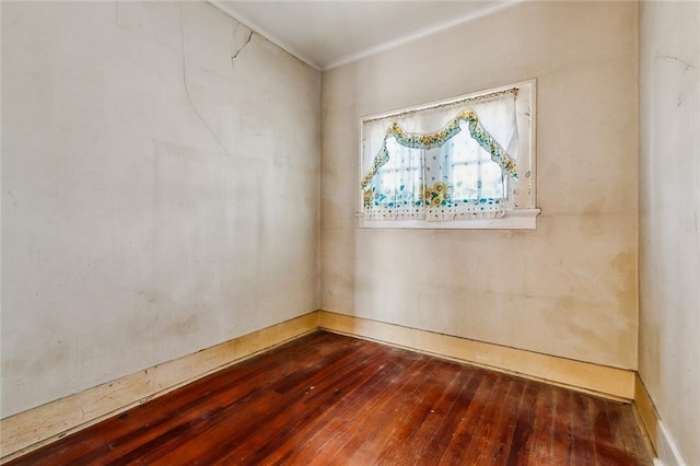 unfurnished room with hardwood / wood-style floors and crown molding