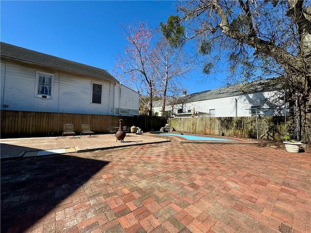 view of yard featuring a fenced in pool, a fenced backyard, and a patio