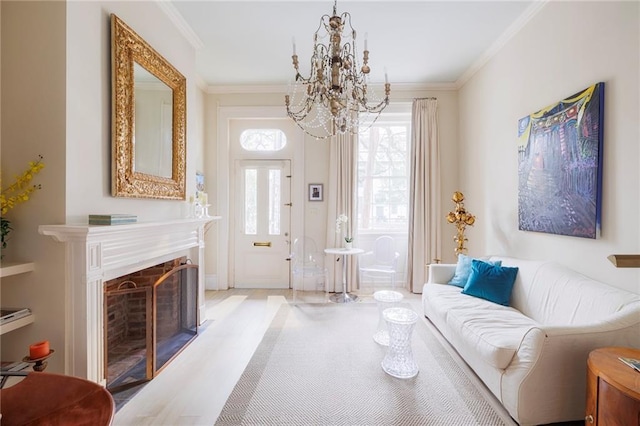 living room with an inviting chandelier and ornamental molding