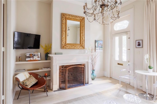 foyer entrance featuring ornamental molding, light hardwood / wood-style floors, and a chandelier