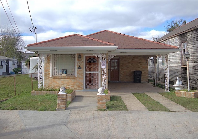 bungalow with a carport and a front yard