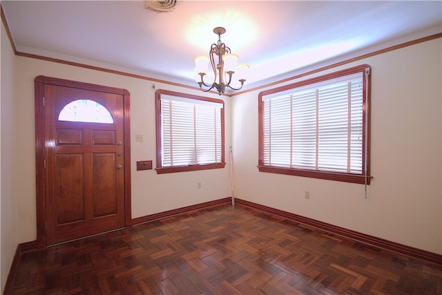 foyer entrance with a notable chandelier and dark parquet floors