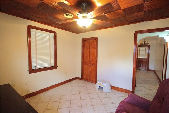 1330 Independence St, New Orleans, LA 70117 - spare room featuring wood ceiling, ceiling fan, and light tile patterned floors