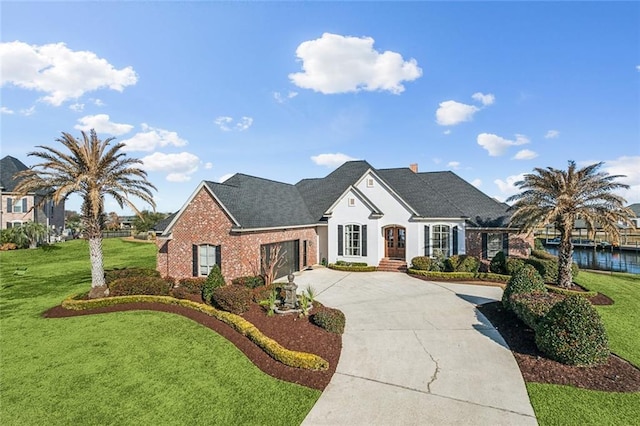 view of front of house featuring a water view, a garage, and a front yard