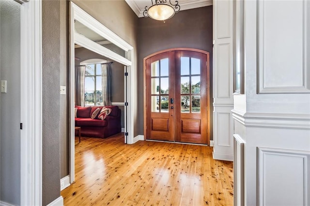 foyer entrance with light hardwood / wood-style floors and french doors