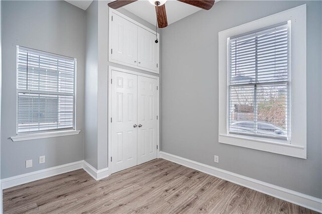 unfurnished bedroom with ceiling fan, light hardwood / wood-style floors, and a closet