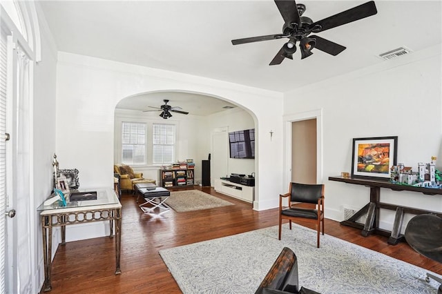 living room with ceiling fan and dark hardwood / wood-style flooring