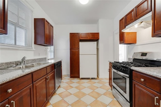 kitchen featuring dishwasher, sink, white fridge, light stone countertops, and stainless steel gas range