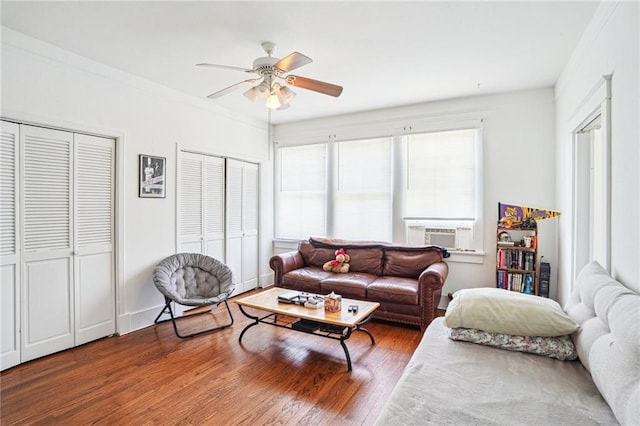 living room featuring hardwood / wood-style flooring, cooling unit, and ceiling fan