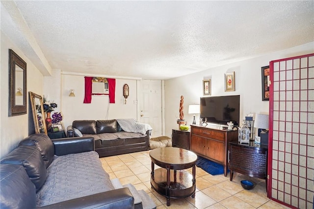 living room featuring a textured ceiling and light tile patterned floors