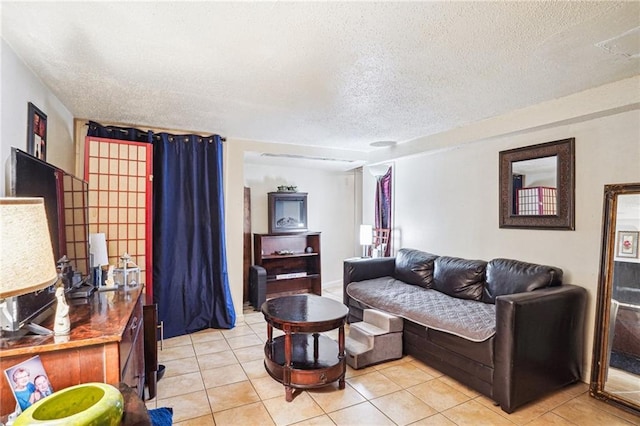 living room with light tile patterned floors and a textured ceiling