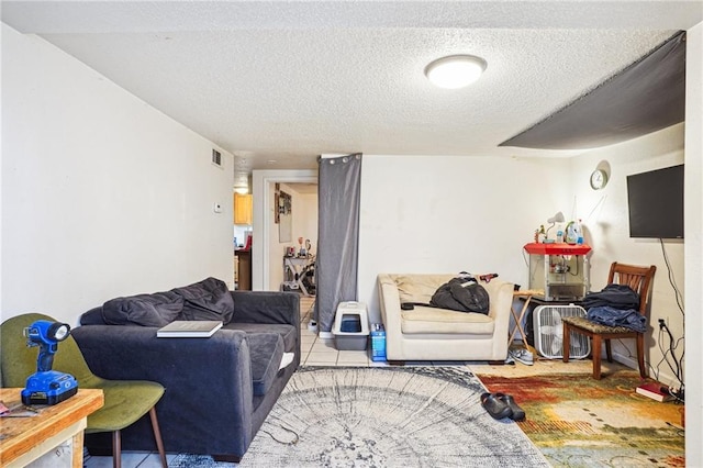 living room featuring tile patterned floors and a textured ceiling