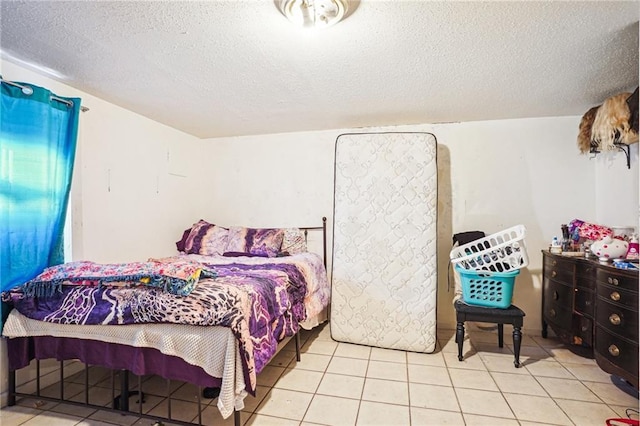 bedroom with light tile patterned flooring and a textured ceiling