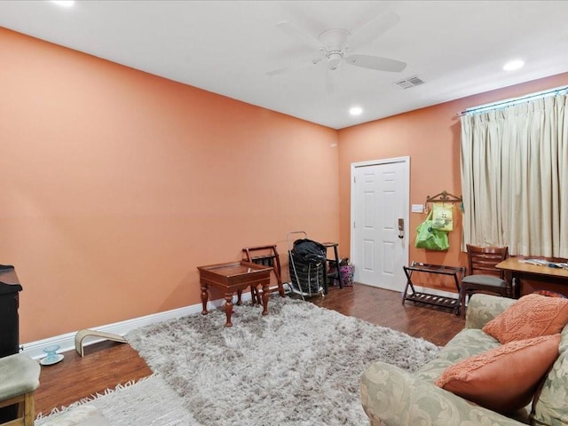 living area with dark hardwood / wood-style floors and ceiling fan