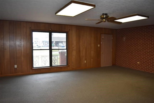 1668 2nd St, Lutcher, LA 70071 - unfurnished room featuring brick wall, carpet flooring, and wooden walls