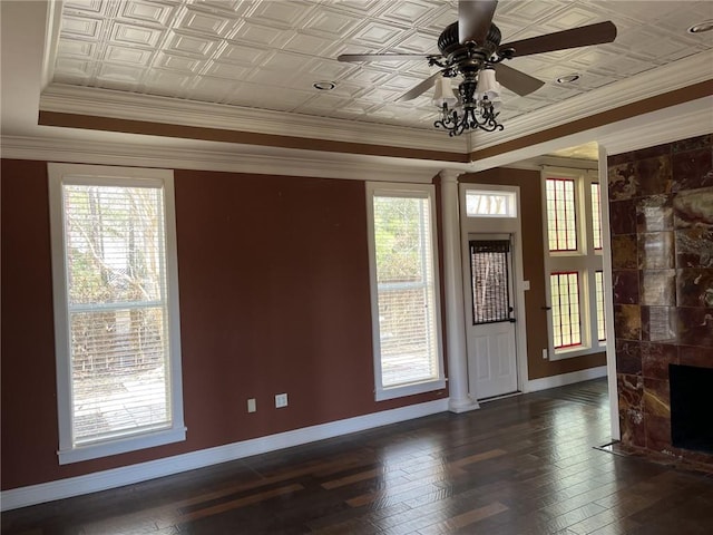 interior space with crown molding, a wealth of natural light, decorative columns, and ceiling fan