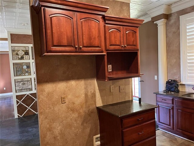 kitchen featuring ornate columns, dark hardwood / wood-style floors, sink, backsplash, and crown molding