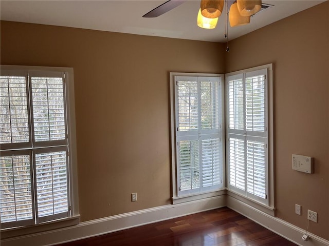 unfurnished room with ceiling fan and dark hardwood / wood-style floors