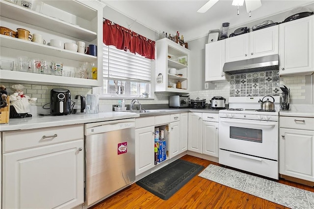 kitchen featuring sink, gas range gas stove, white cabinetry, wood-type flooring, and dishwasher