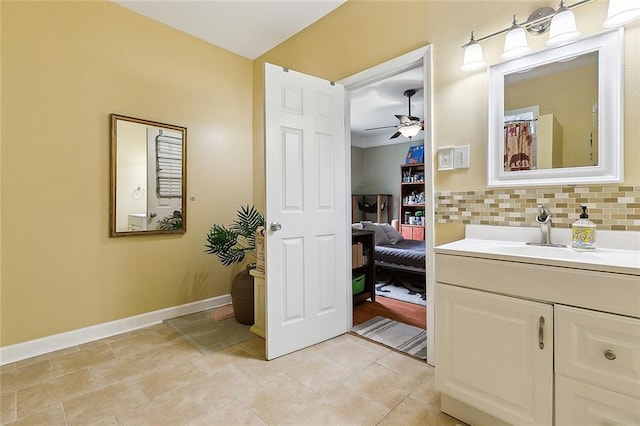 bathroom featuring ceiling fan, vanity, tile patterned floors, and backsplash