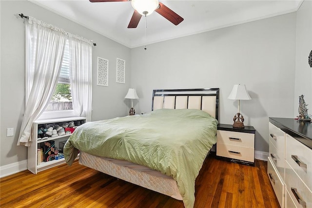 bedroom with crown molding, dark hardwood / wood-style floors, and ceiling fan