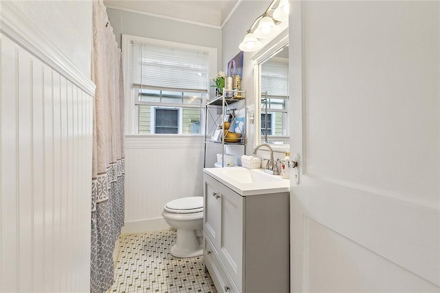 bathroom with vanity, ornamental molding, and toilet