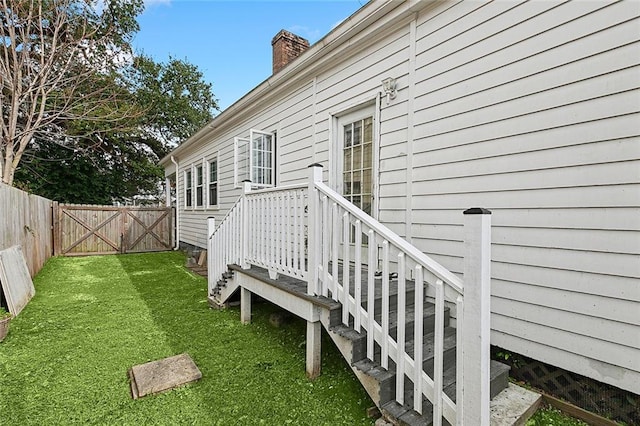 doorway to property featuring a yard