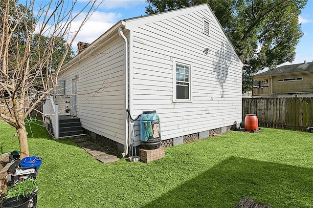 view of home's exterior with a lawn