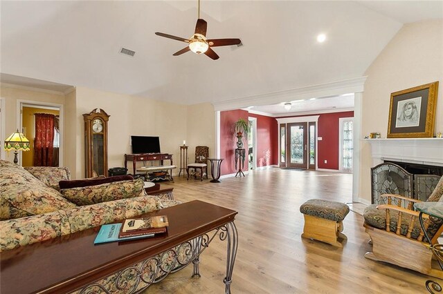 living room featuring ceiling fan with notable chandelier, high vaulted ceiling, and light hardwood / wood-style floors