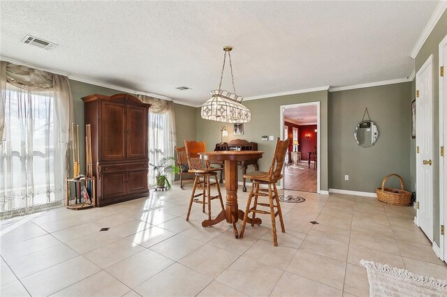 bedroom with crown molding, light colored carpet, and a textured ceiling