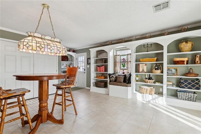 carpeted bedroom featuring ornamental molding, a closet, and a textured ceiling