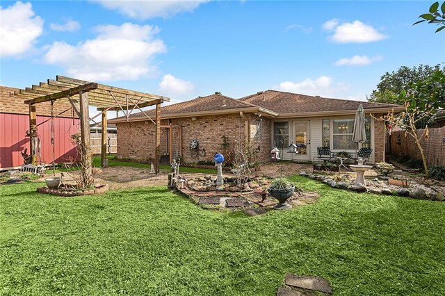 rear view of house with a yard and a pergola