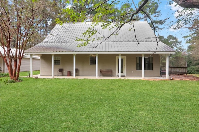 rear view of property with a yard and a patio area