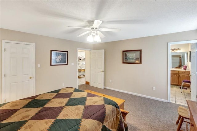 bedroom with connected bathroom, light carpet, and ceiling fan