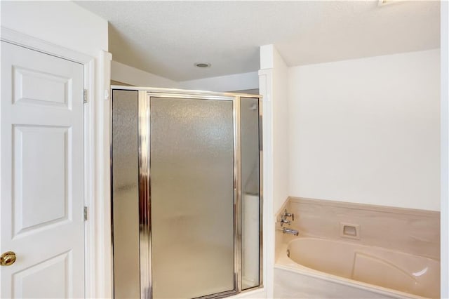 bathroom featuring separate shower and tub