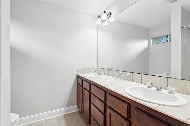 bathroom with tile patterned flooring, vanity, walk in shower, and toilet