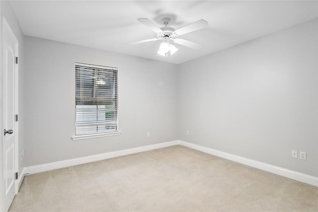 spare room with light carpet and ceiling fan