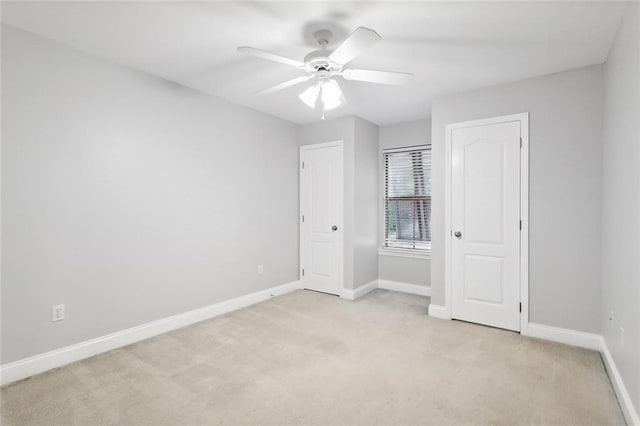 unfurnished bedroom with light colored carpet and ceiling fan