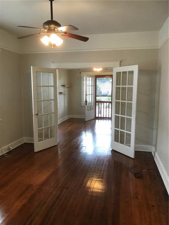 spare room with french doors, ceiling fan, and dark hardwood / wood-style floors