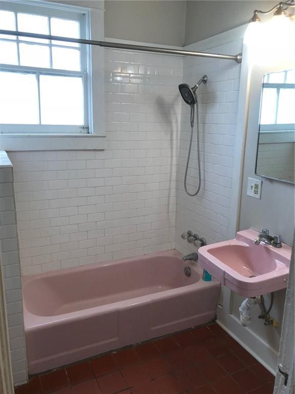 bathroom featuring sink, tiled shower / bath combo, and tile patterned floors