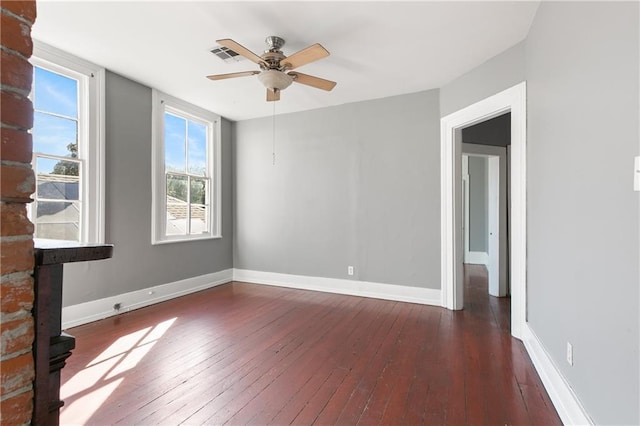 spare room featuring dark hardwood / wood-style flooring and ceiling fan