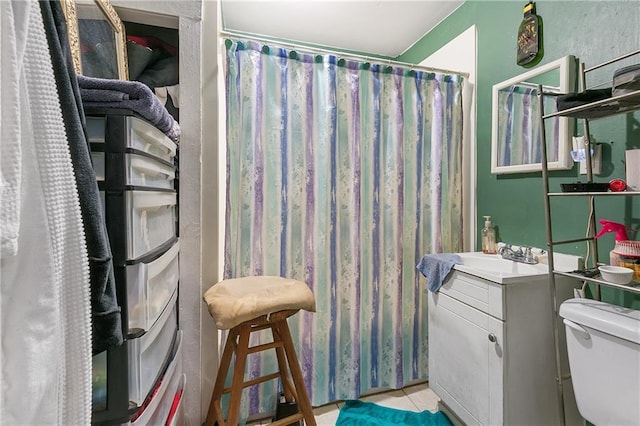 bathroom with a shower with curtain, vanity, toilet, and tile patterned flooring