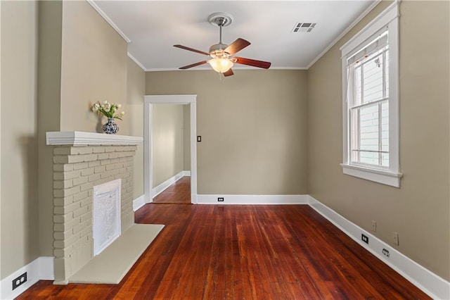 unfurnished living room with crown molding, ceiling fan, a fireplace, and dark hardwood / wood-style flooring