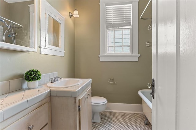 bathroom featuring tile patterned floors, vanity, and toilet