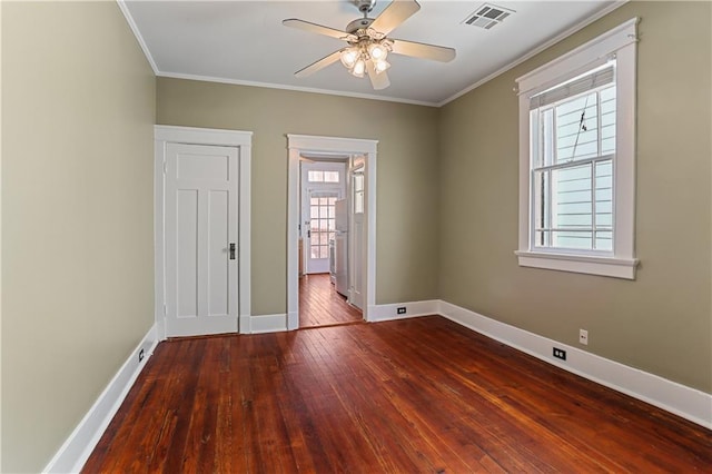 unfurnished room with crown molding, ceiling fan, and dark hardwood / wood-style floors