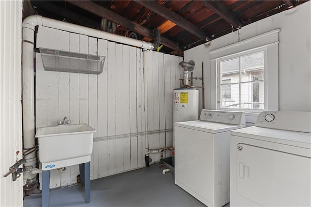 laundry room with washing machine and dryer and wood walls