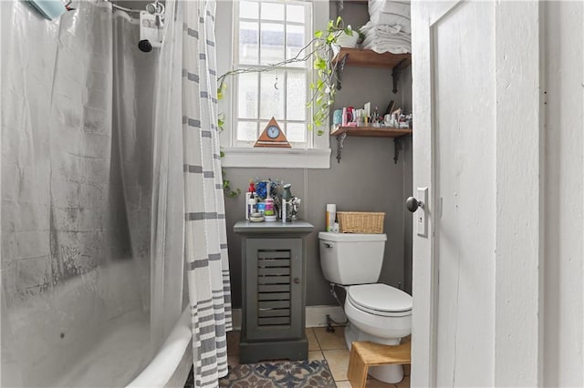 bathroom featuring shower / tub combo with curtain, toilet, and tile patterned flooring