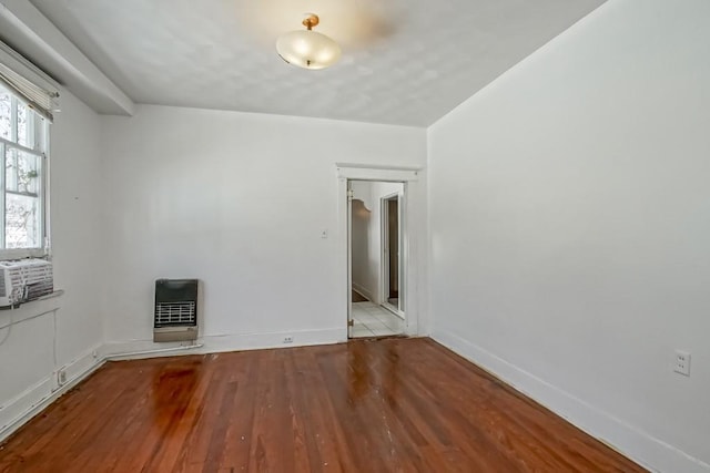 empty room with heating unit and light hardwood / wood-style flooring