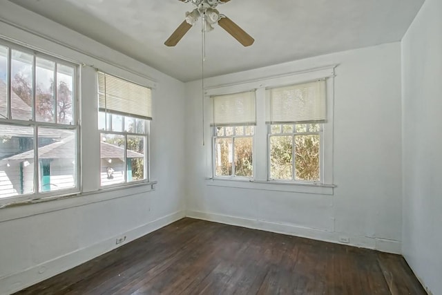 empty room with dark hardwood / wood-style flooring, ceiling fan, and a healthy amount of sunlight